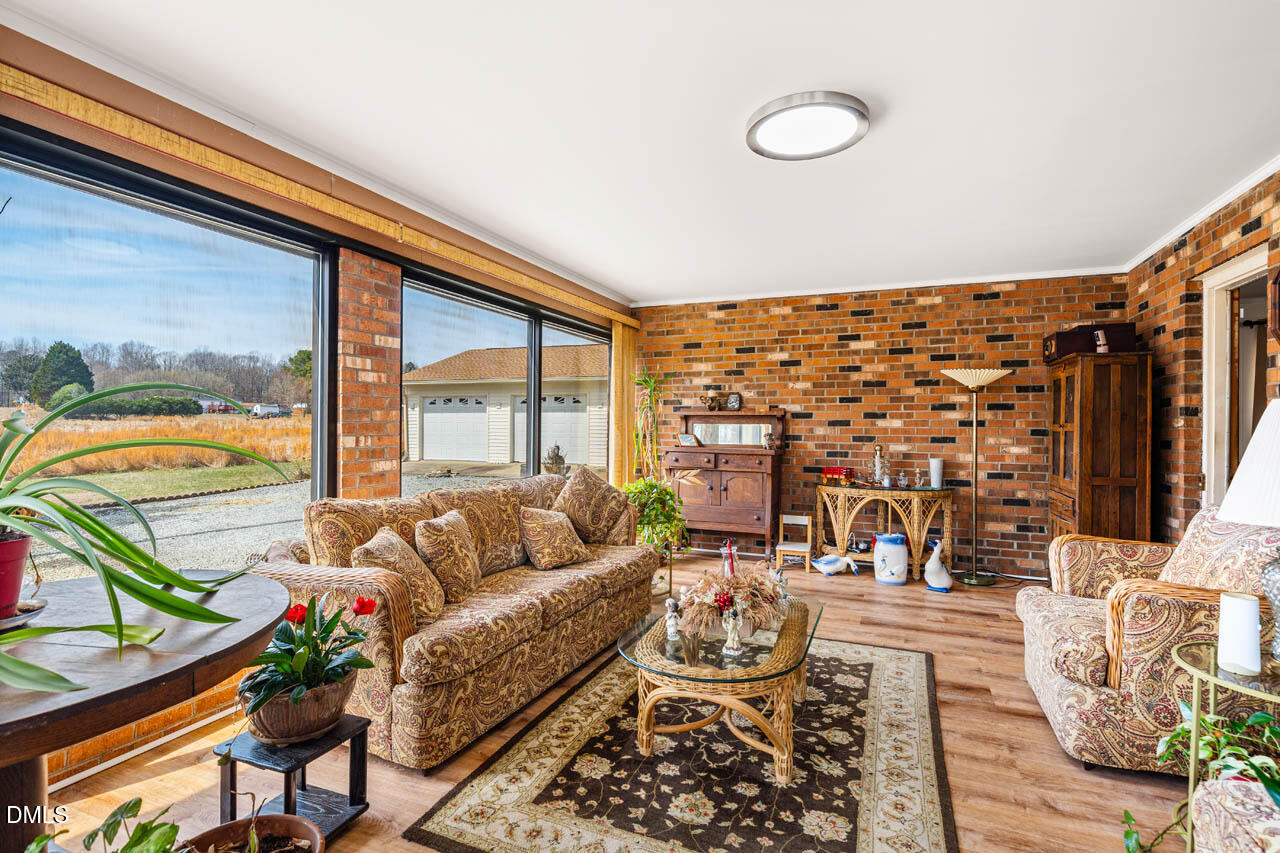 200 Sawmill Road Cedar Grove, NC 27231 - Photo 2 of 72 a living room with furniture and a floor to ceiling window