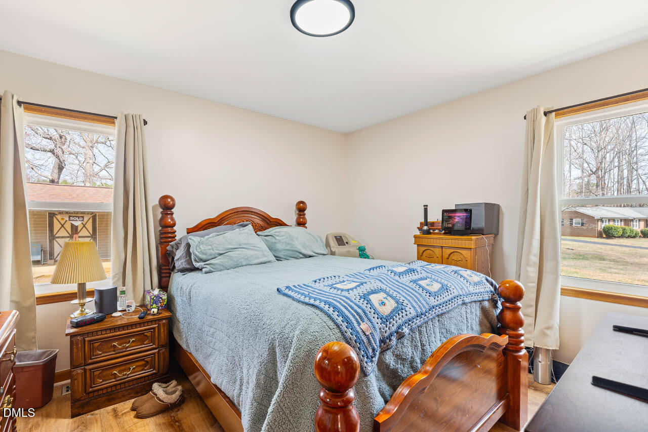 200 Sawmill Road Cedar Grove, NC 27231 - Photo 21 of 72 a bedroom with a bed and wooden floor
