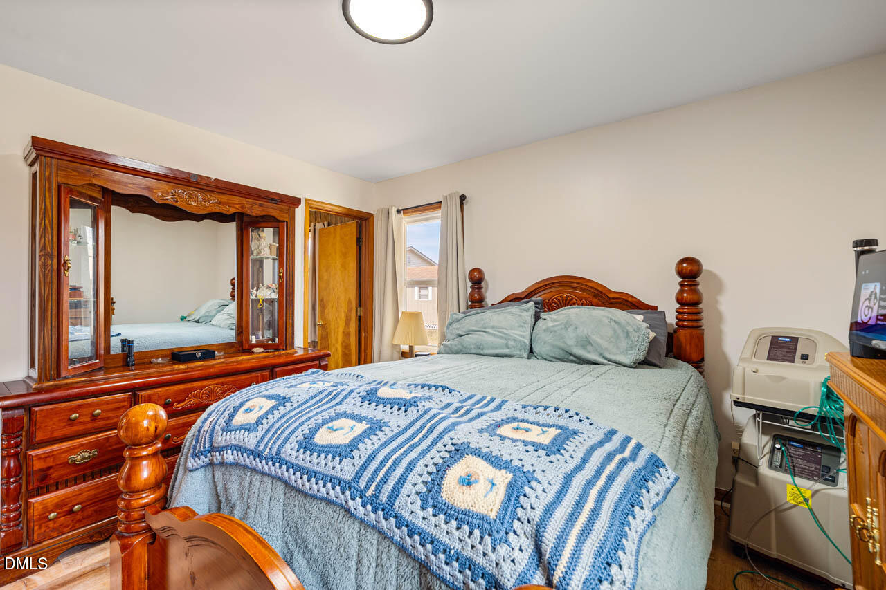 200 Sawmill Road Cedar Grove, NC 27231 - Photo 22 of 72 a bedroom with a bed and a mirror on dresser