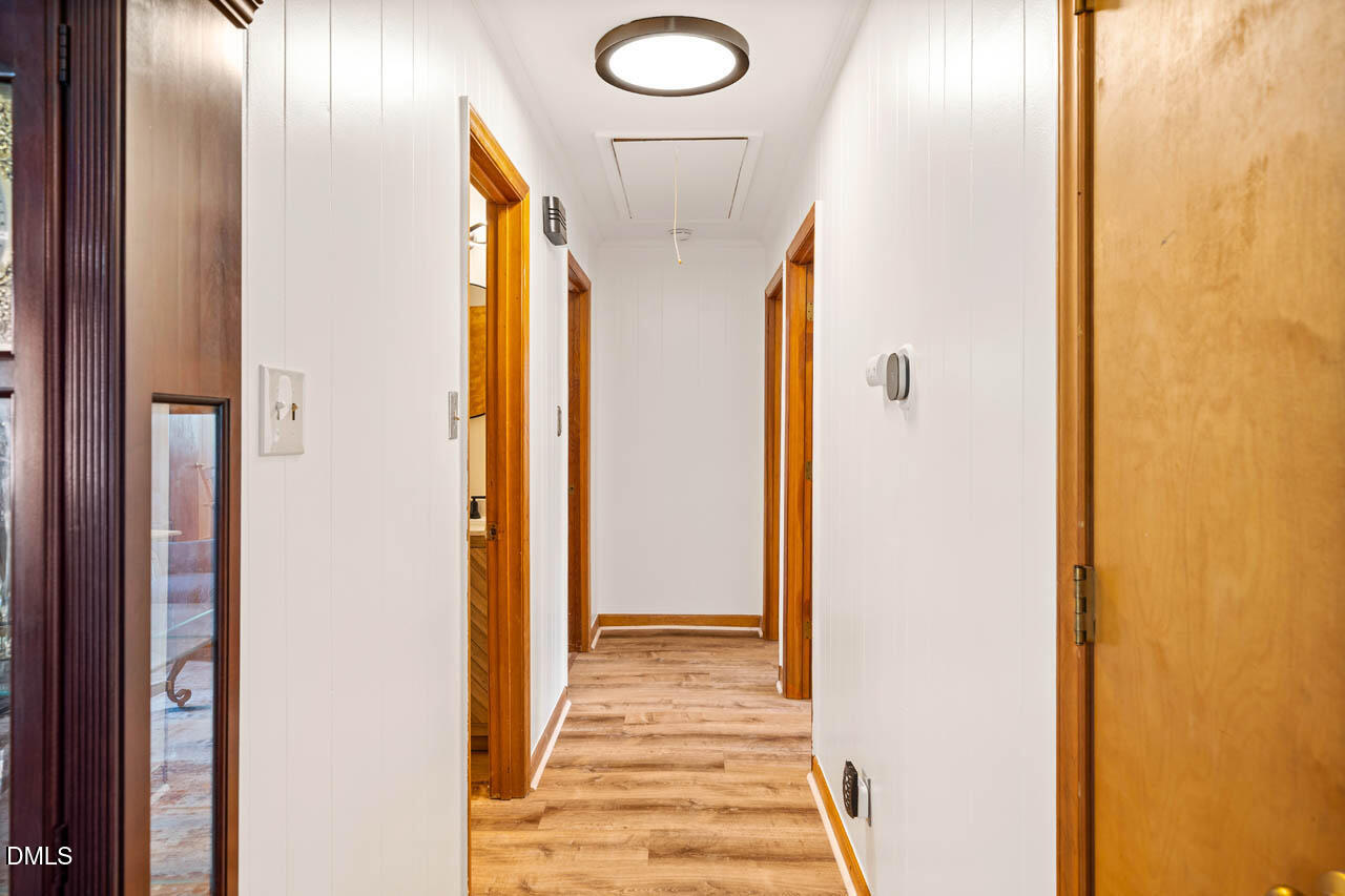 200 Sawmill Road Cedar Grove, NC 27231 - Photo 25 of 72 a view of a hallway with wooden floor and glass doors
