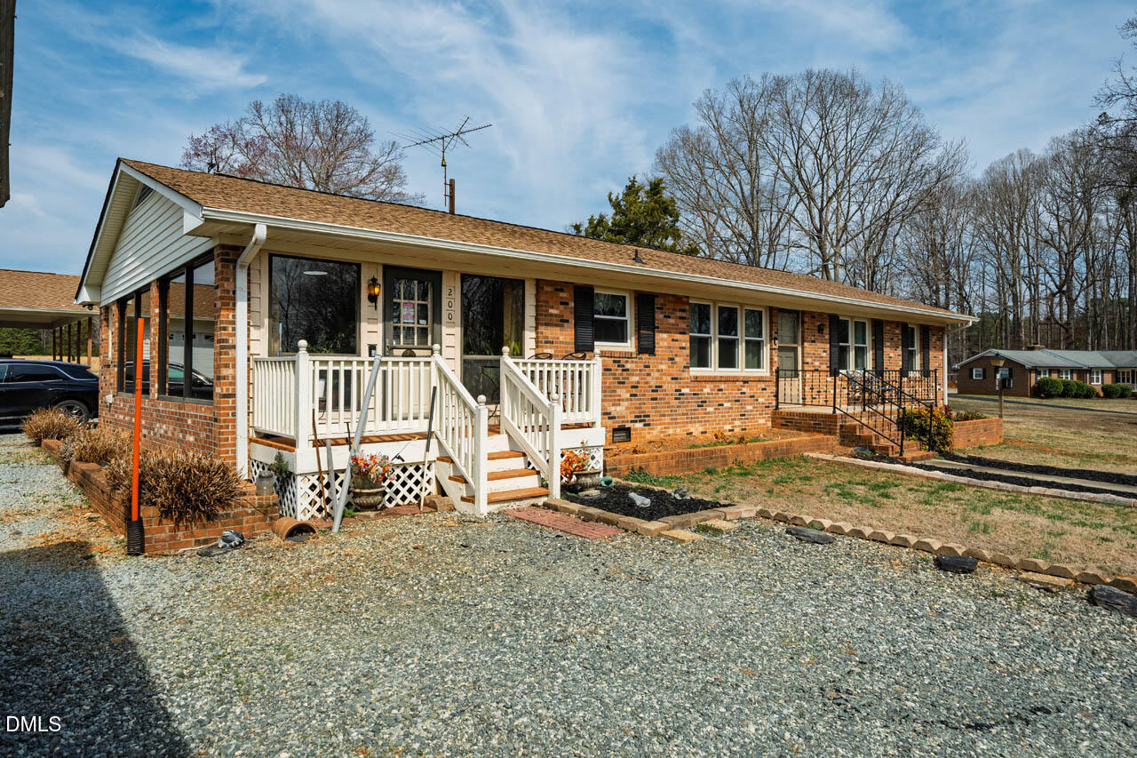 200 Sawmill Road Cedar Grove, NC 27231 - Photo 29 of 72 a view of a house with a yard and wooden fence