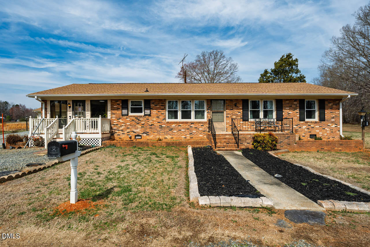 200 Sawmill Road Cedar Grove, NC 27231 - Photo 30 of 72 a front view of a house with garden