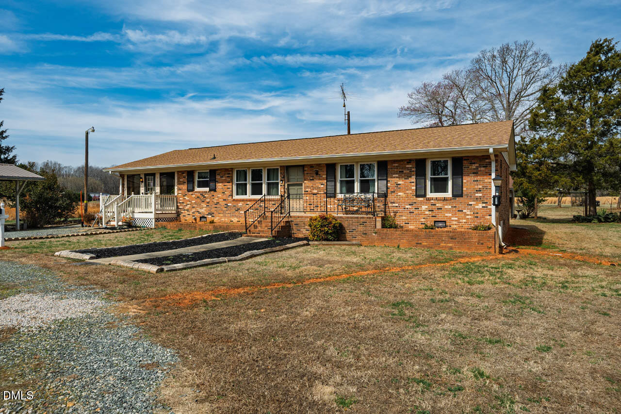 200 Sawmill Road Cedar Grove, NC 27231 - Photo 31 of 72 a view of a house with a yard patio and a tree