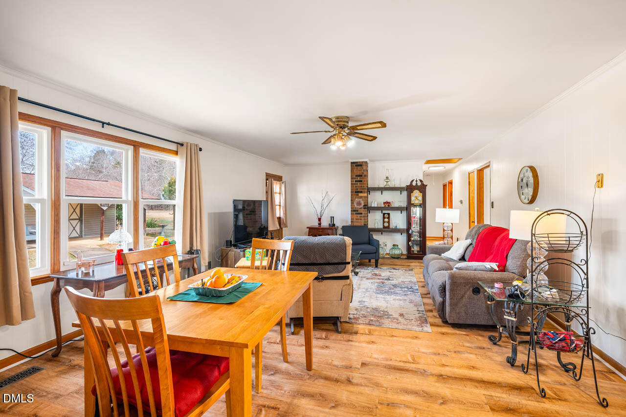 200 Sawmill Road Cedar Grove, NC 27231 - Photo 4 of 72 a living room with furniture a dining table and a floor to ceiling window