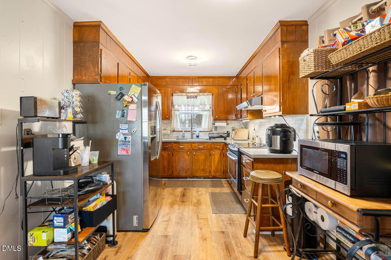 200 Sawmill Road Cedar Grove, NC 27231 - Photo 8 of 72 a view of a kitchen with workspace and natural light