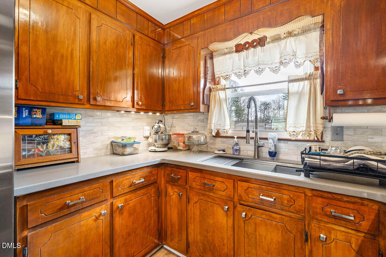 200 Sawmill Road Cedar Grove, NC 27231 - Photo 10 of 72 a kitchen with stainless steel appliances granite countertop a sink a stove and cabinets