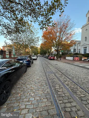 a city street lined with buildings and trees