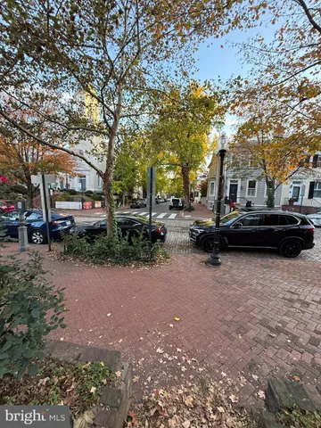 a view of backyard with wooden fence