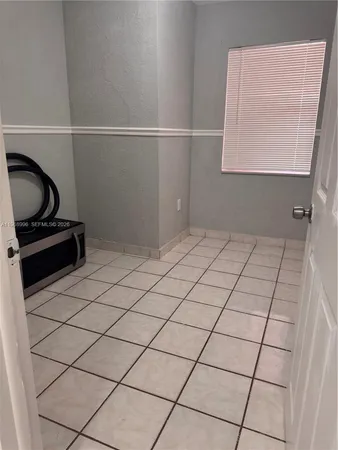 a kitchen with a sink a refrigerator and wooden cabinets