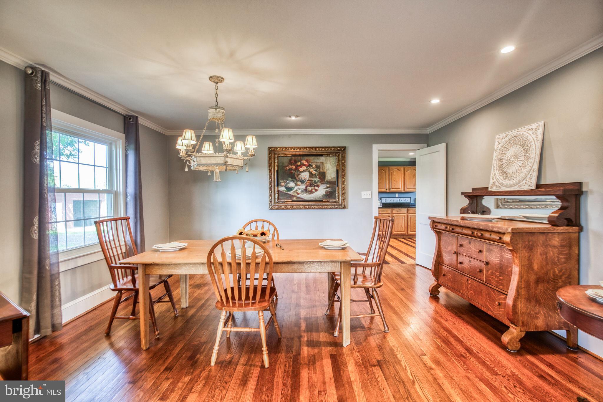 1815 Country Road Beaverdam, VA 23015 - Photo 14 of 92 a view of a dining room with furniture a chandelier and wooden floor