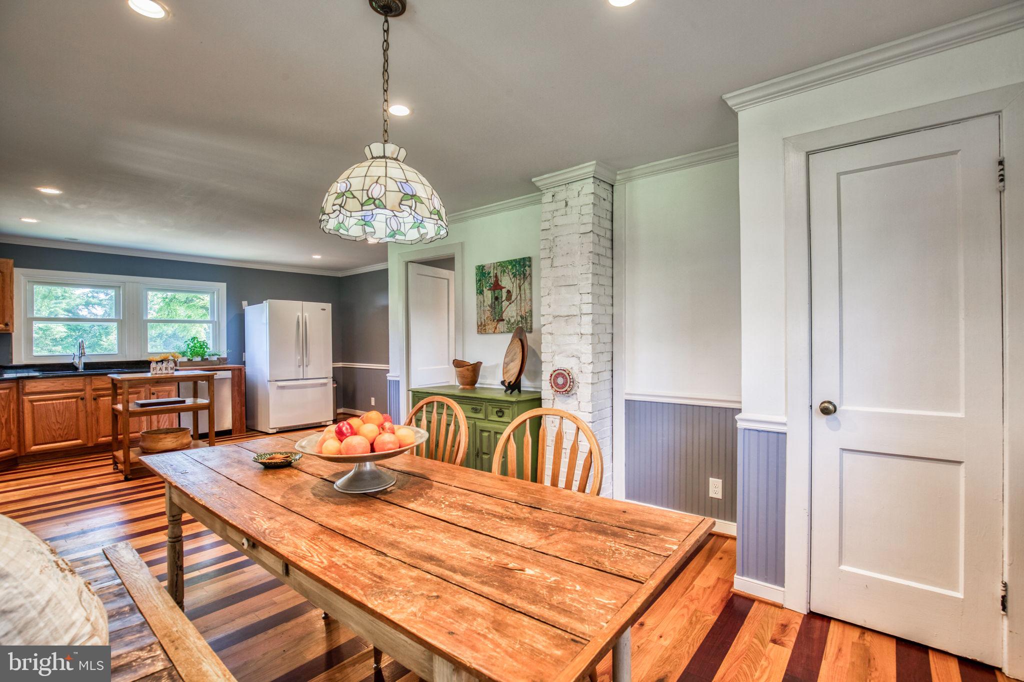 1815 Country Road Beaverdam, VA 23015 - Photo 23 of 92 a dining room with furniture a chandelier and wooden floor