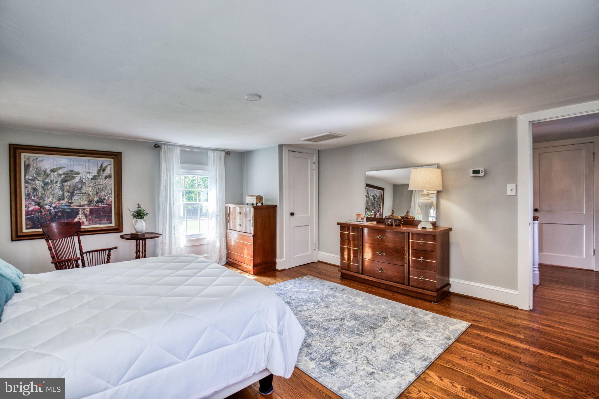 1815 Country Road Beaverdam, VA 23015 - Photo 29 of 92 a bedroom with a large bed and a dresser