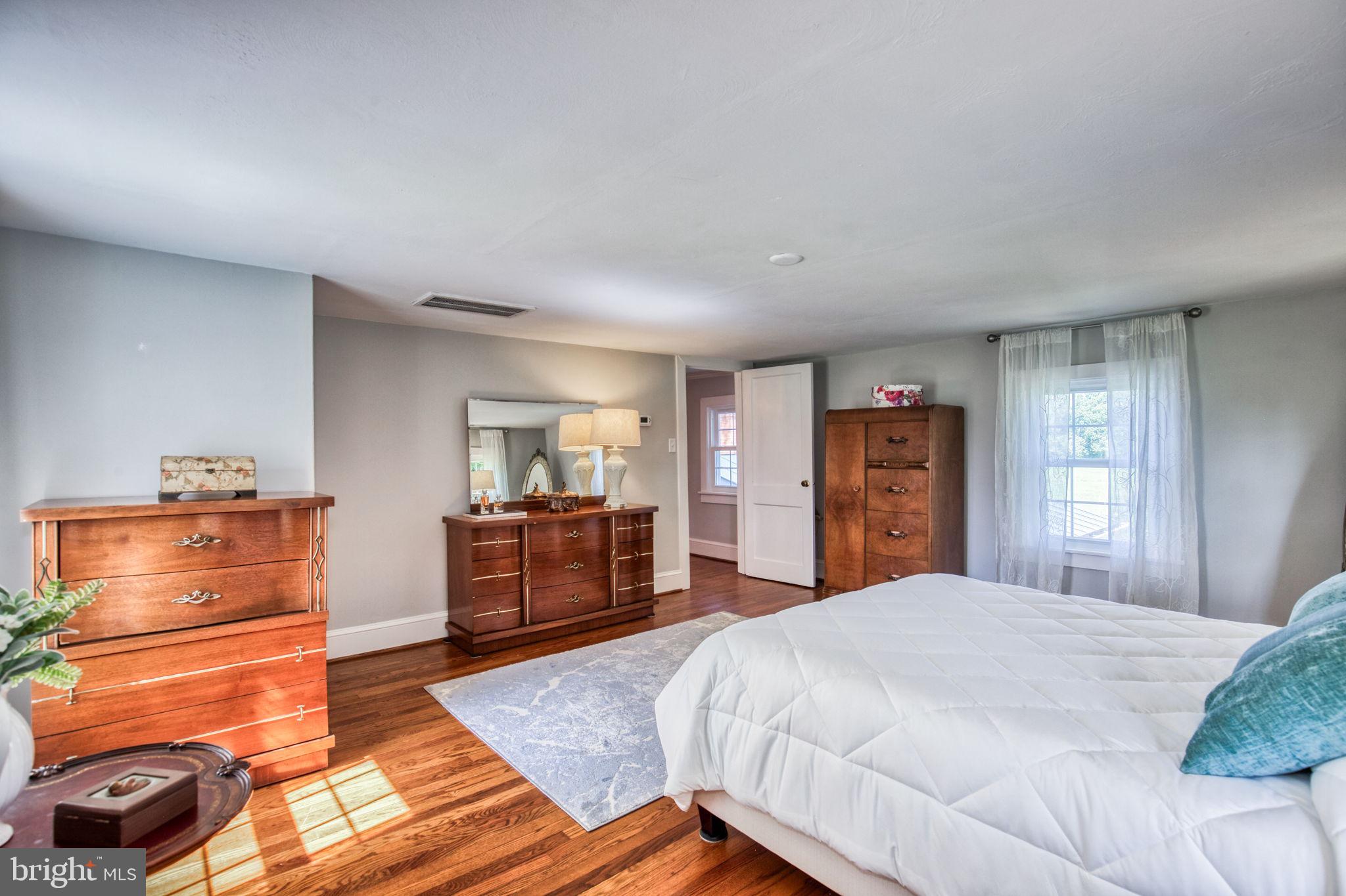 1815 Country Road Beaverdam, VA 23015 - Photo 30 of 92 a bedroom with a bed and wooden floor