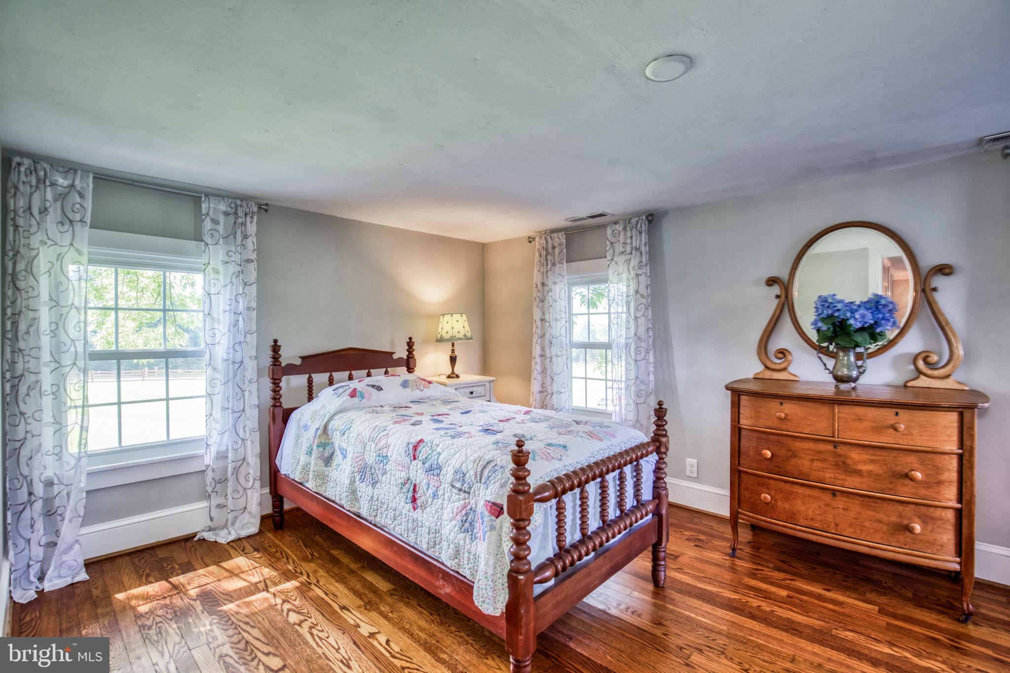 1815 Country Road Beaverdam, VA 23015 - Photo 33 of 92 a bedroom with a bed and wooden floor