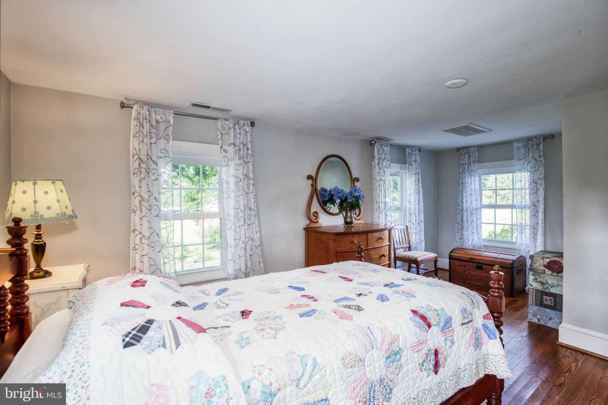 1815 Country Road Beaverdam, VA 23015 - Photo 34 of 92 a bedroom with a bed and a dresser next to a window