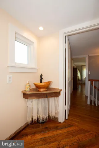 a view of a backyard with potted plants and large tree