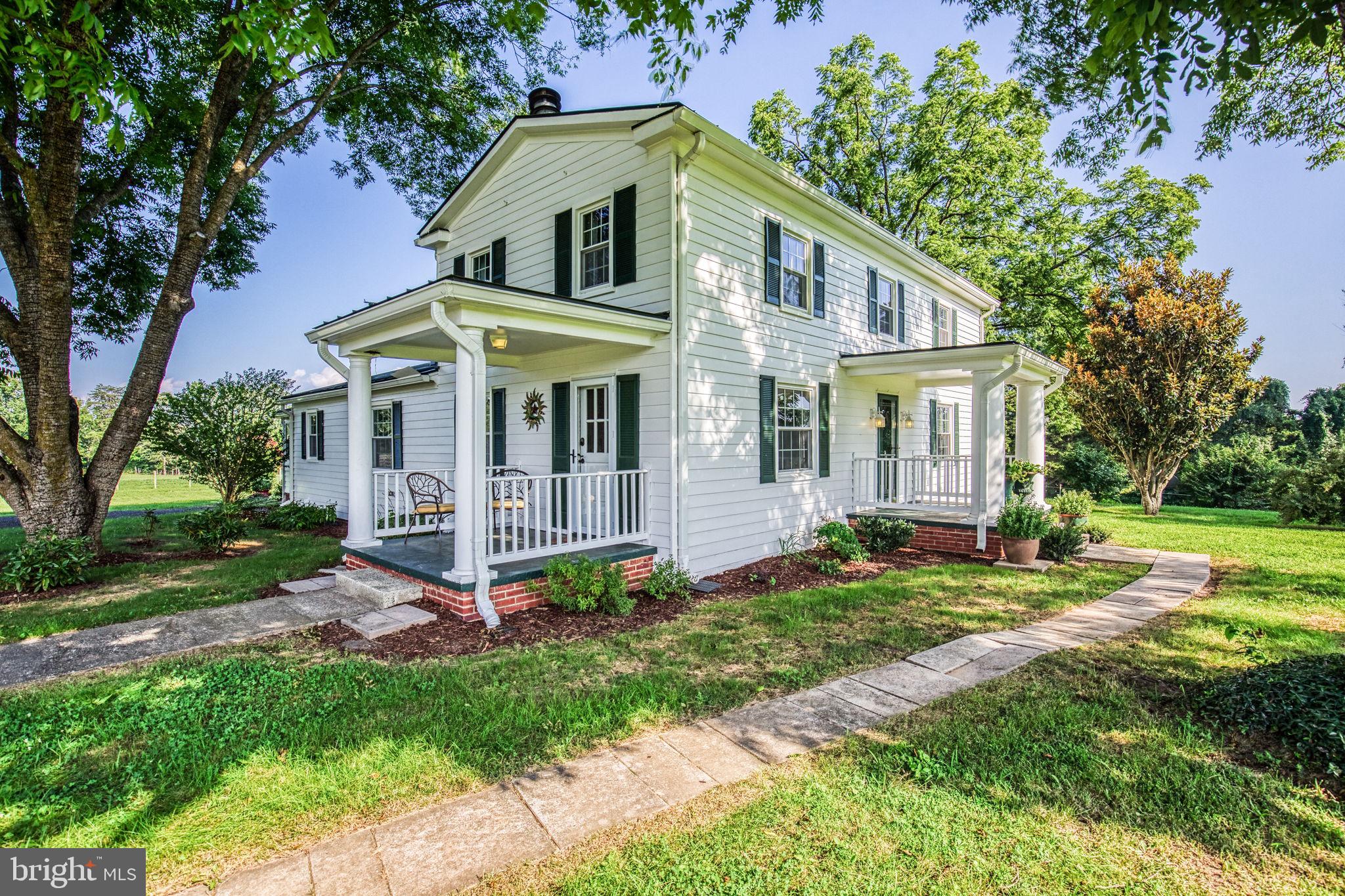 1815 Country Road Beaverdam, VA 23015 - Photo 4 of 92 a view of a white house with a yard and plants