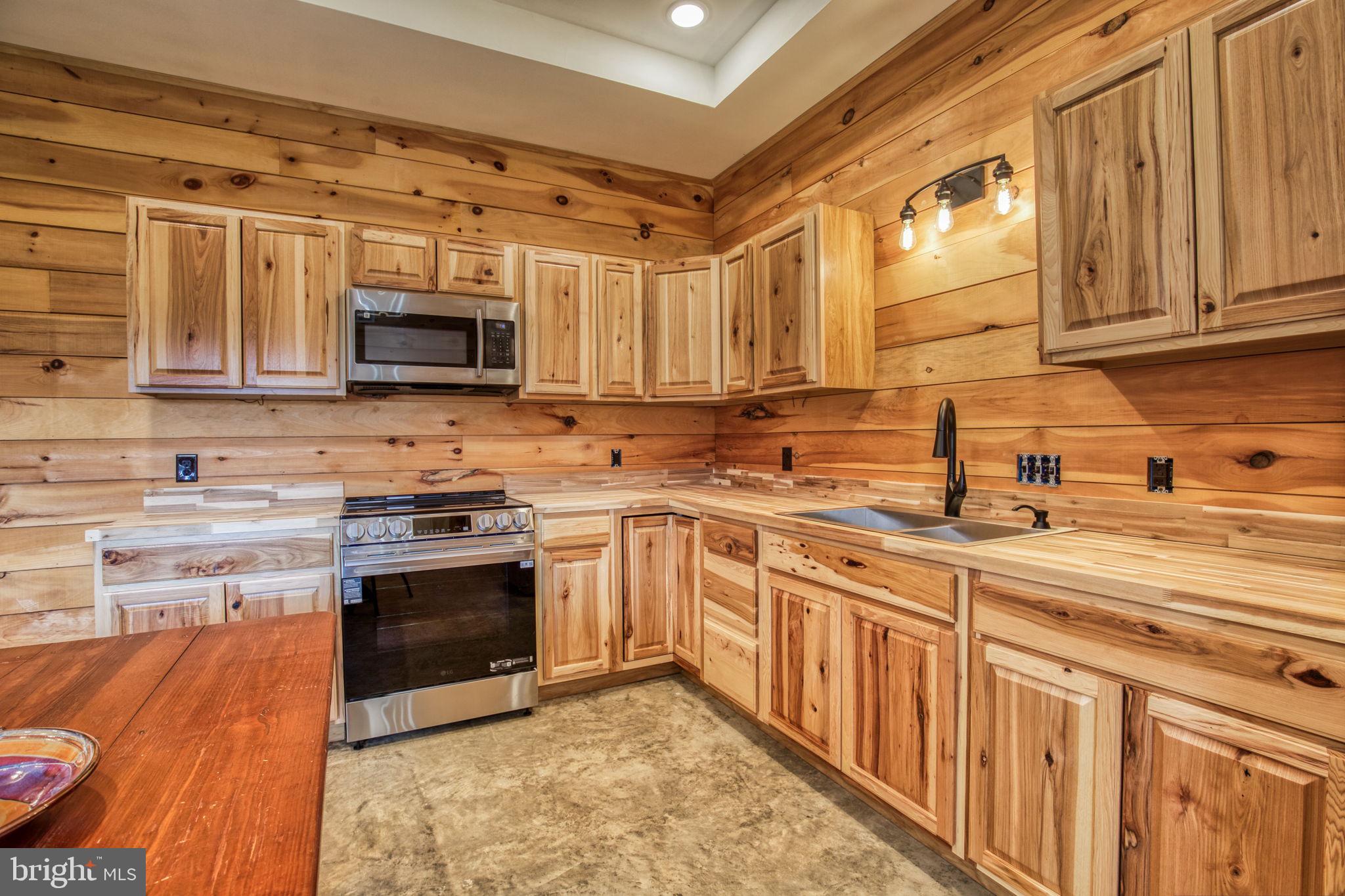 1815 Country Road Beaverdam, VA 23015 - Photo 70 of 92 a kitchen with stainless steel appliances granite countertop a stove sink microwave and cabinets