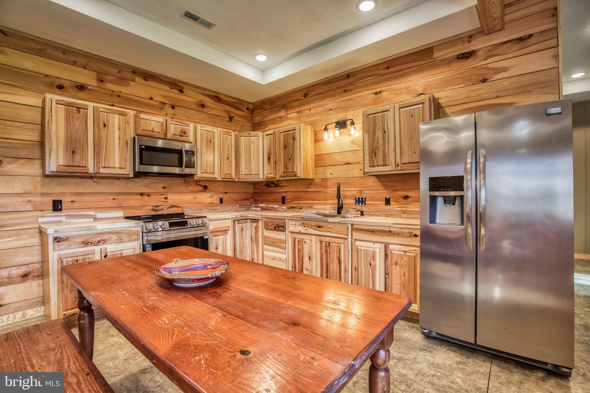 1815 Country Road Beaverdam, VA 23015 - Photo 73 of 92 a kitchen with stainless steel appliances granite countertop a refrigerator a stove and a sink with wooden floor