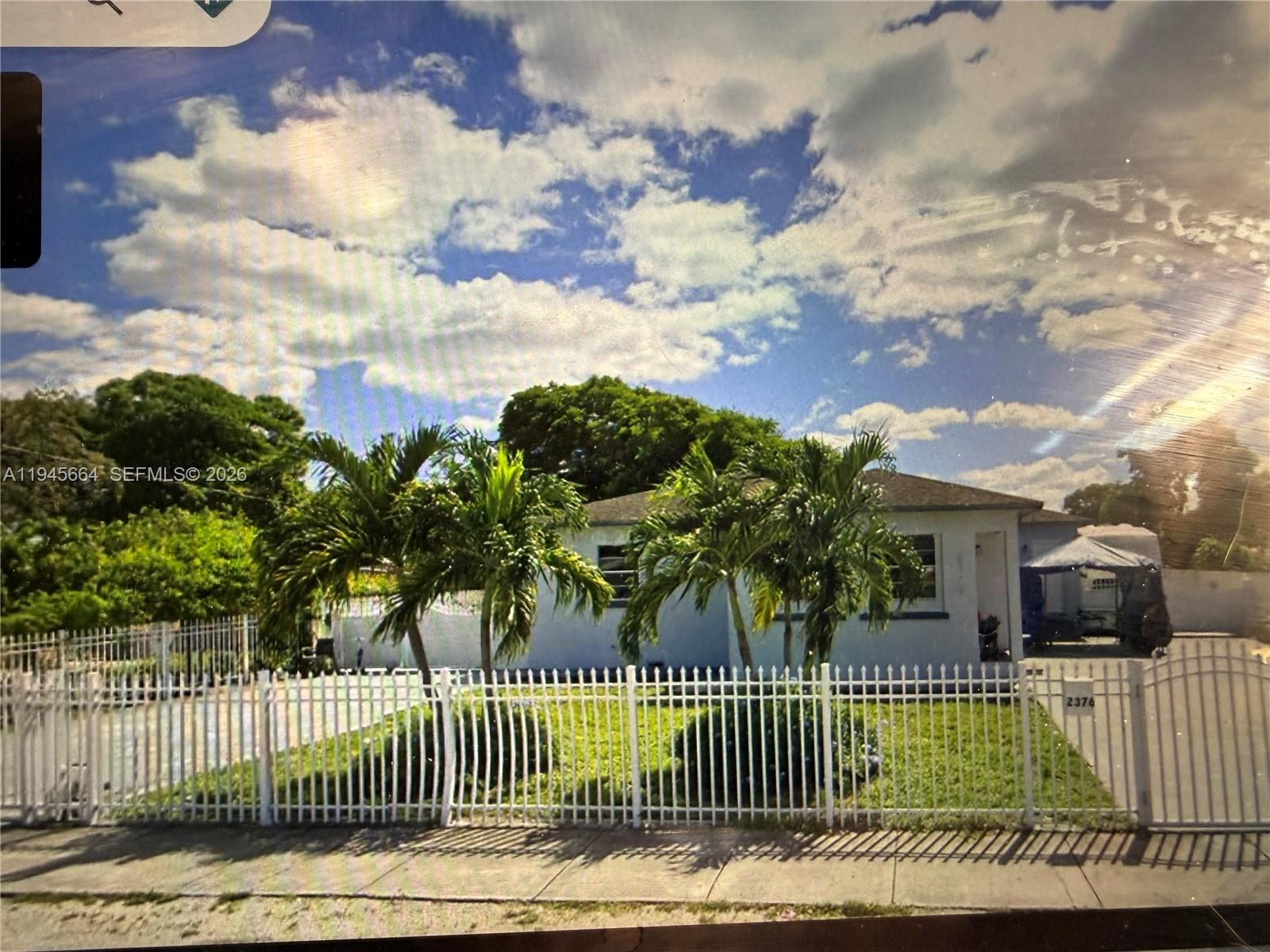 2376 Northwest 104th Street Miami, FL 33147 - Photo 3 of 7 a view of a house with a garden and plants