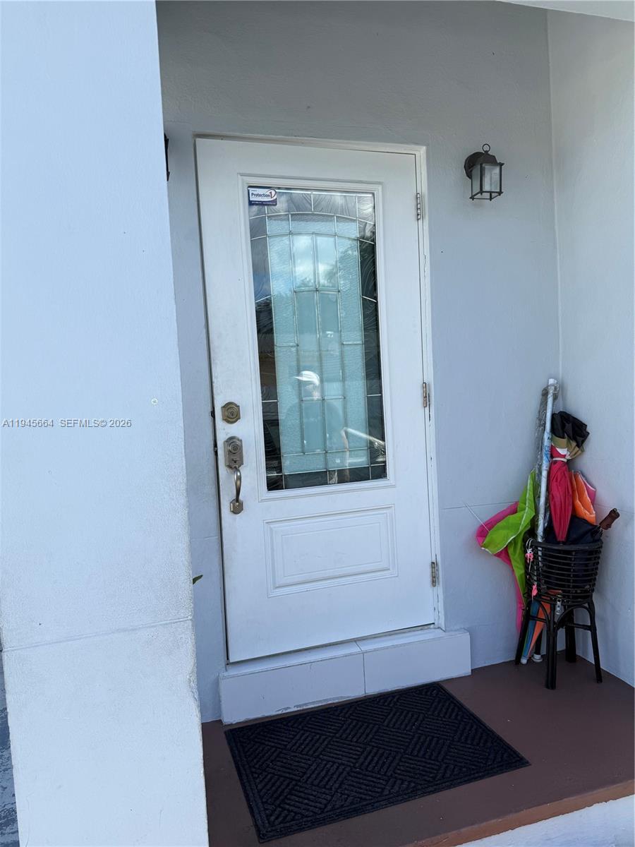 2376 Northwest 104th Street Miami, FL 33147 - Photo 5 of 7 a hallway with painting on the wall and a potted plant