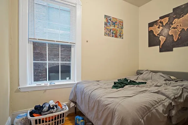 a bed sitting in a bedroom next to a window