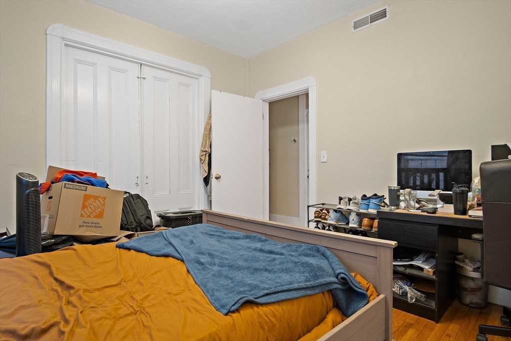 852 Huntington Avenue, Unit 2 Boston, MA 02115 - Photo 7 of 15 a bedroom with a bed and a computer on a desk
