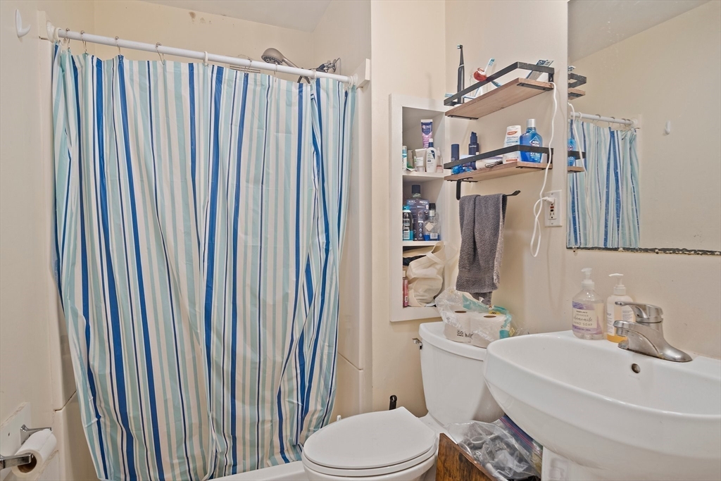 852 Huntington Avenue, Unit 2 Boston, MA 02115 - Photo 9 of 15 a bathroom with a sink a toilet and shower