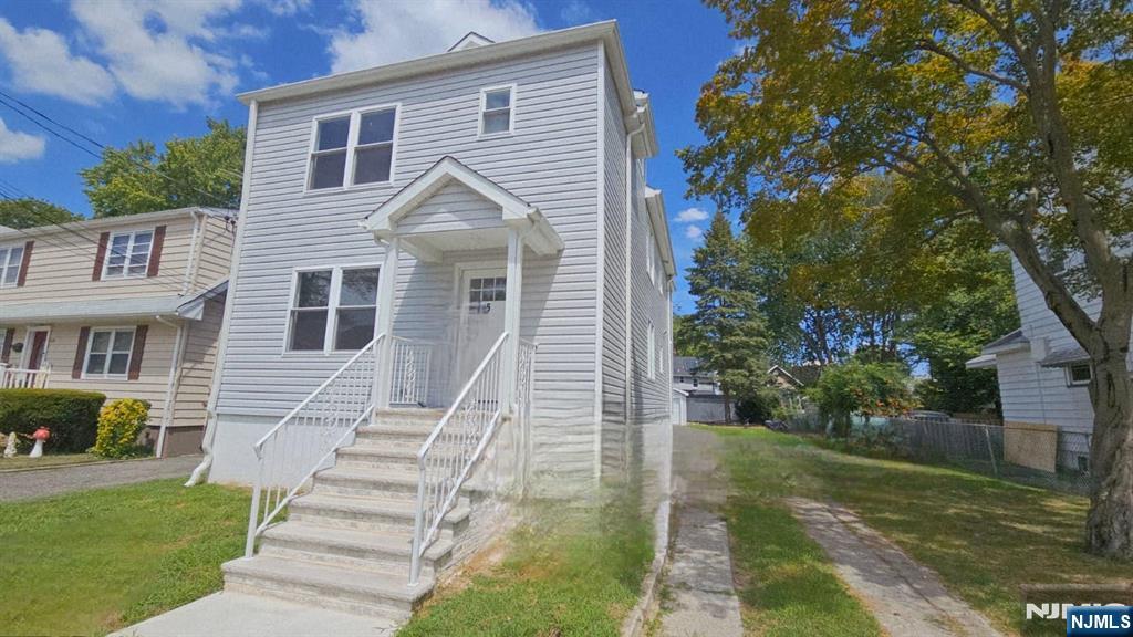125 Birch Street, Unit 2 Bloomfield, NJ 07003 - Photo 2 of 11 a view of a white house next to a yard with big trees