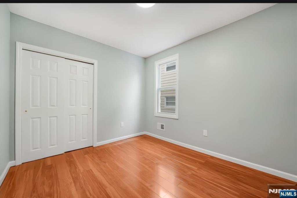 125 Birch Street, Unit 2 Bloomfield, NJ 07003 - Photo 8 of 11 a view of empty room with wooden floor