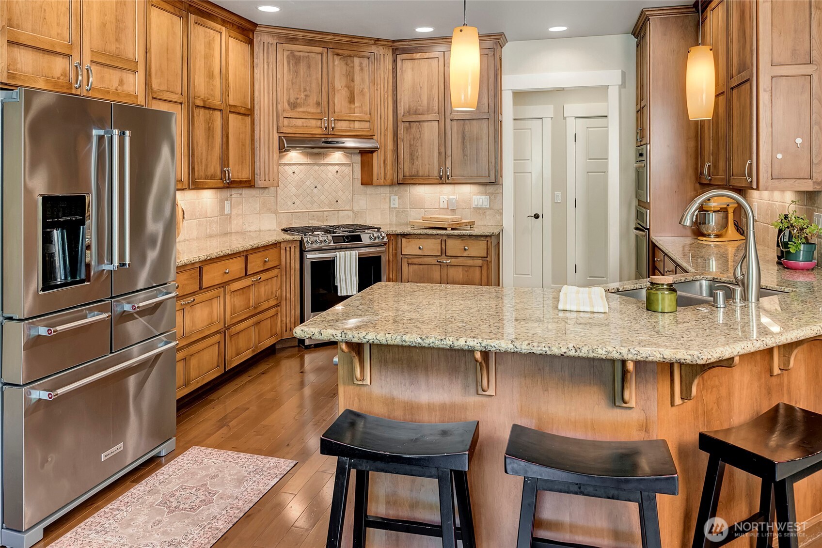 8211 Spada Road Snohomish, WA 98290 - Photo 11 of 35 a kitchen with stainless steel appliances granite countertop a kitchen island a stove a cabinets a sink and a refrigerator
