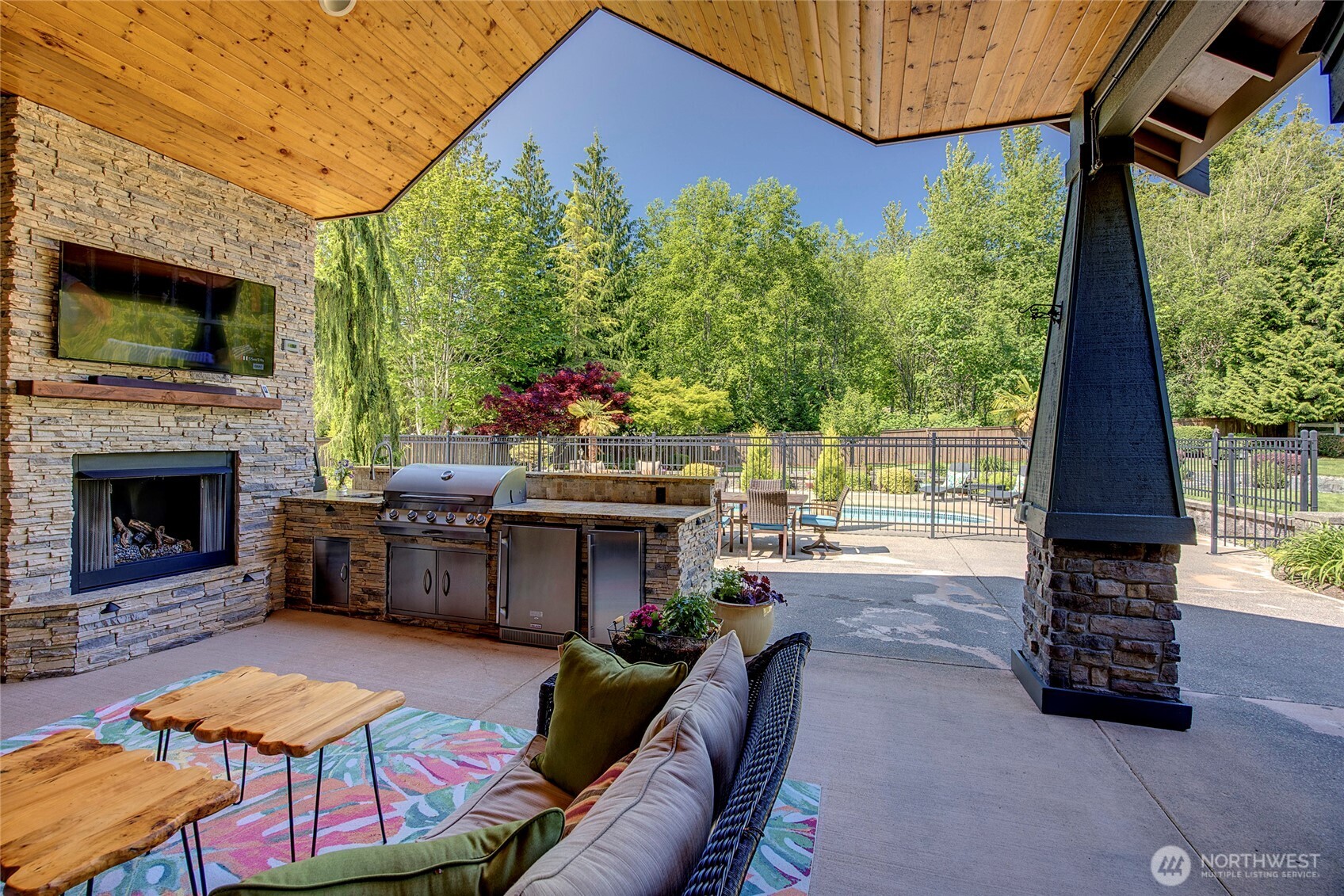 8211 Spada Road Snohomish, WA 98290 - Photo 26 of 35 a living room with furniture a flat screen tv and a fireplace