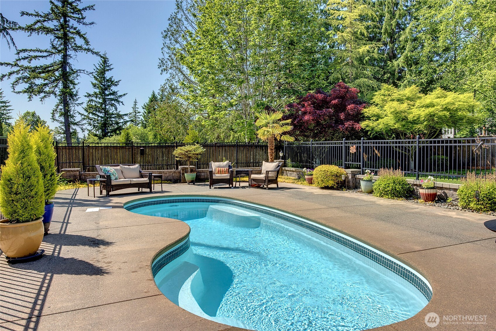 8211 Spada Road Snohomish, WA 98290 - Photo 27 of 35 a swimming pool with outdoor seating and garden