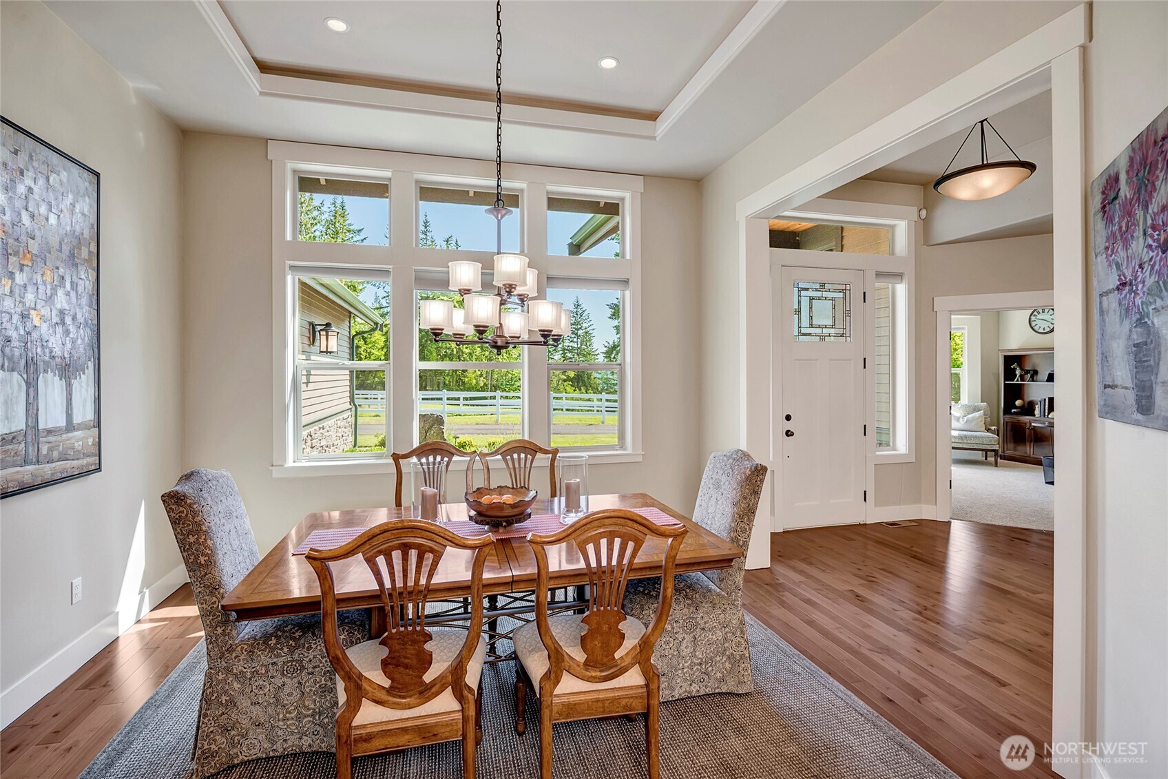 8211 Spada Road Snohomish, WA 98290 - Photo 6 of 35 a dining room with furniture a chandelier and wooden floor