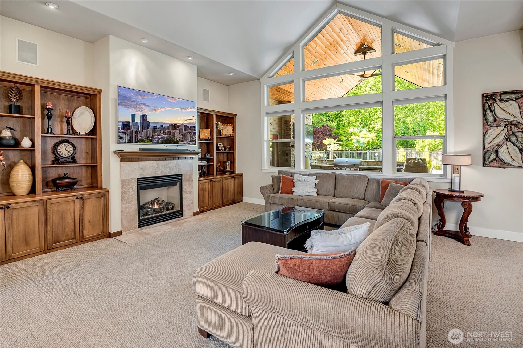 8211 Spada Road Snohomish, WA 98290 - Photo 8 of 35 a living room with furniture a fireplace and a flat screen tv