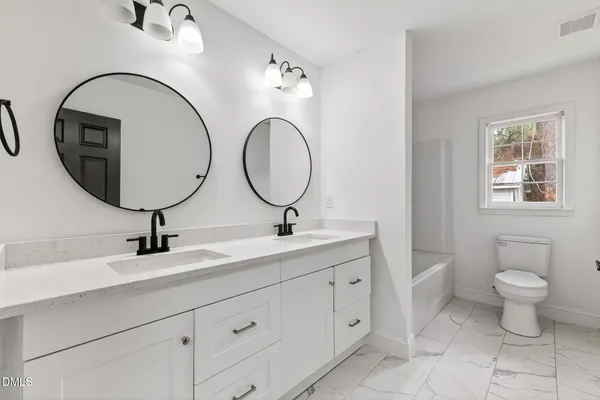 a view of an empty room with a fireplace and a window