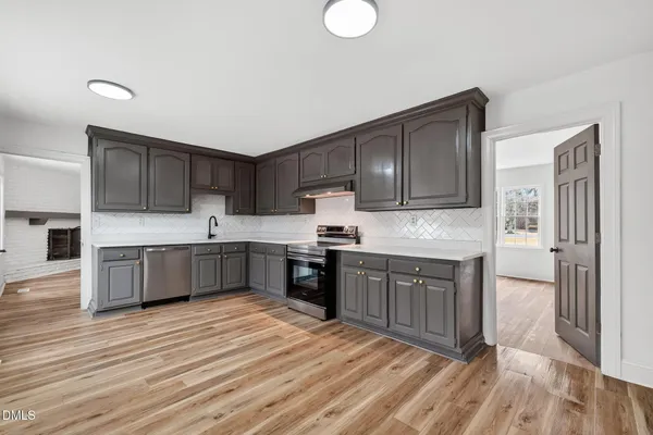 a kitchen with granite countertop cabinets and stainless steel appliances