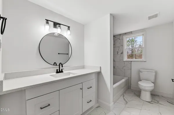 a view of a big room with wooden floor and windows