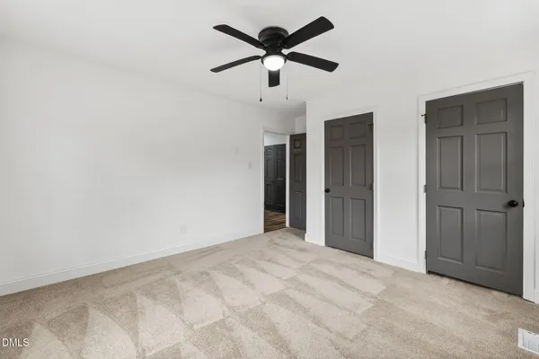 a view of a big room with closet and windows