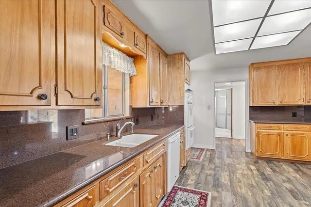 a kitchen with stainless steel appliances a sink and a stove