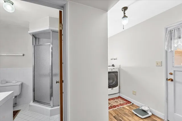 a bathroom with a toilet and a shower