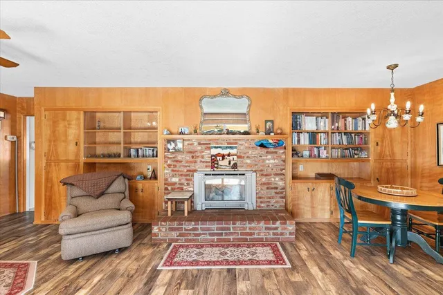 a living room with furniture a rug and a chandelier