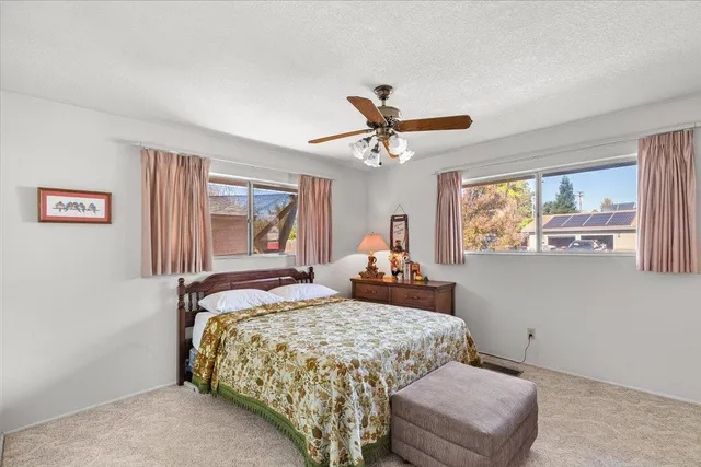 a bedroom with a large bed and a chandelier