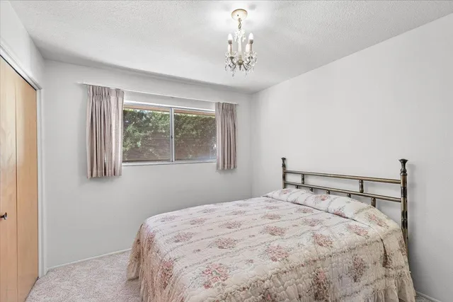 a bedroom with a large bed and a window