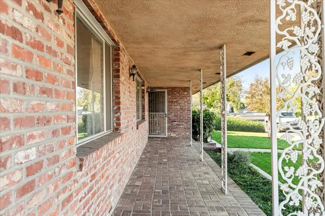 a view of a porch with wooden floor and fence