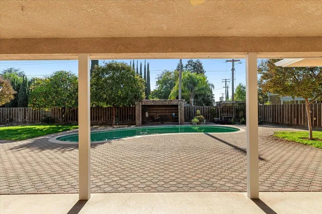 a view of a backyard with wooden floor and floor to ceiling window