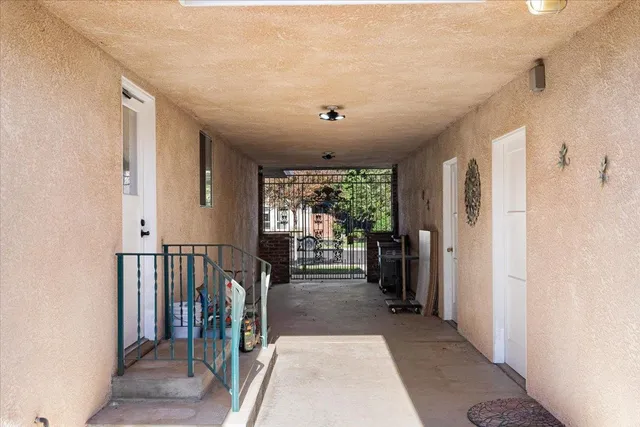 a view of a hallway with furniture