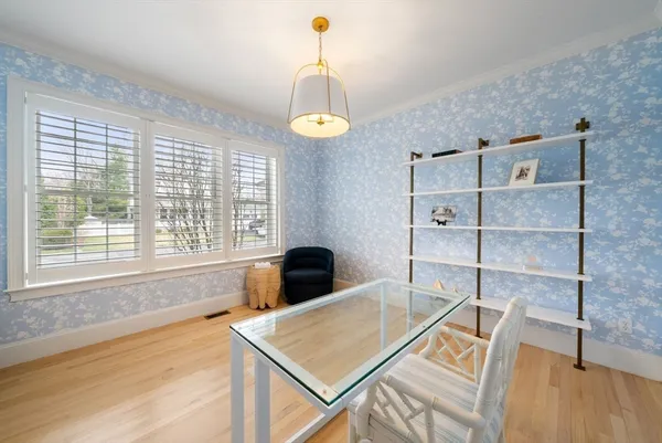 a view of a workspace with furniture and a window