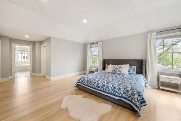 a bedroom with a bed and wooden floor
