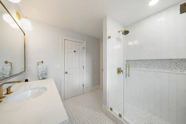a bathroom with a sink and shower